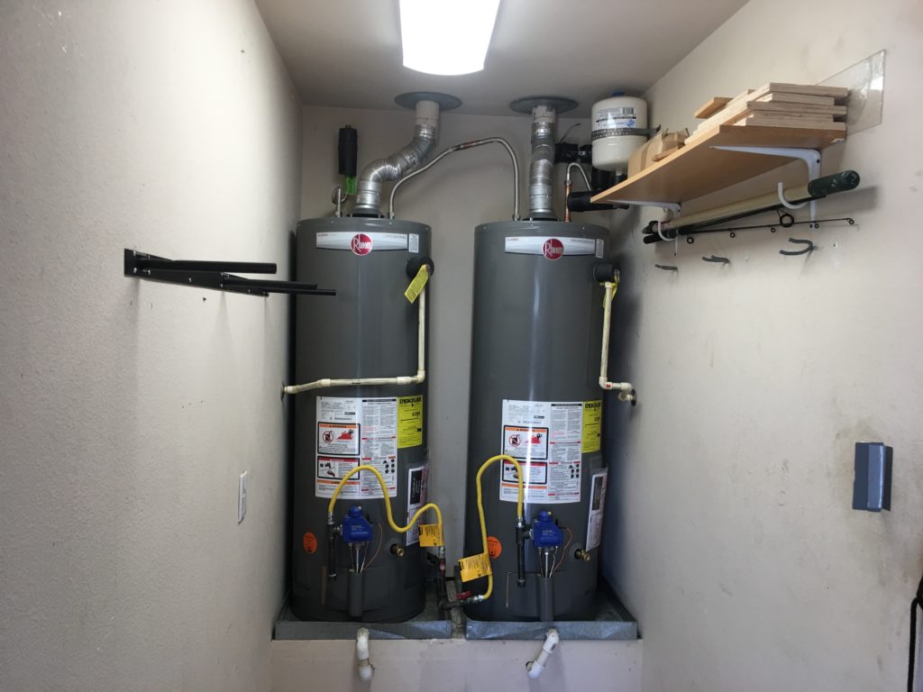 two water heaters inside a closet