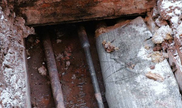 A look at pipes underneath a home.