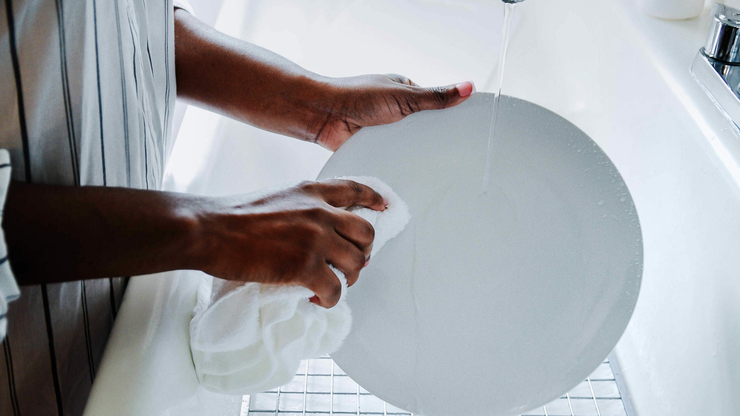 woman washing dishes at the sink